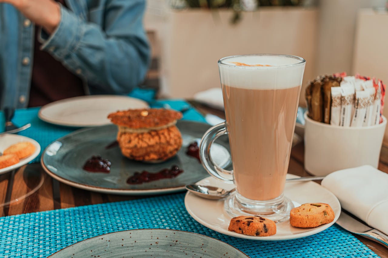 Enjoy a cozy cafe brunch in Dubai with a frothy latte and delicious pastries.
